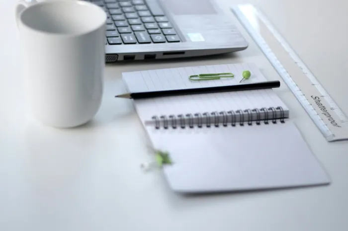 stock image of a notebook, mug and laptop